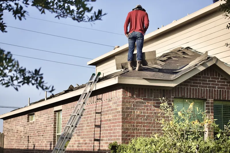 Professional roofer working on a residential roof in Brothertown